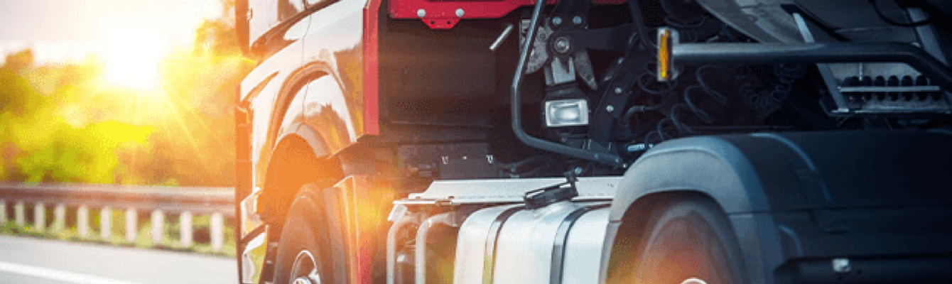 Truck driving with sun in background