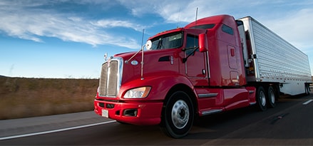 Red commercial vehicle on the road